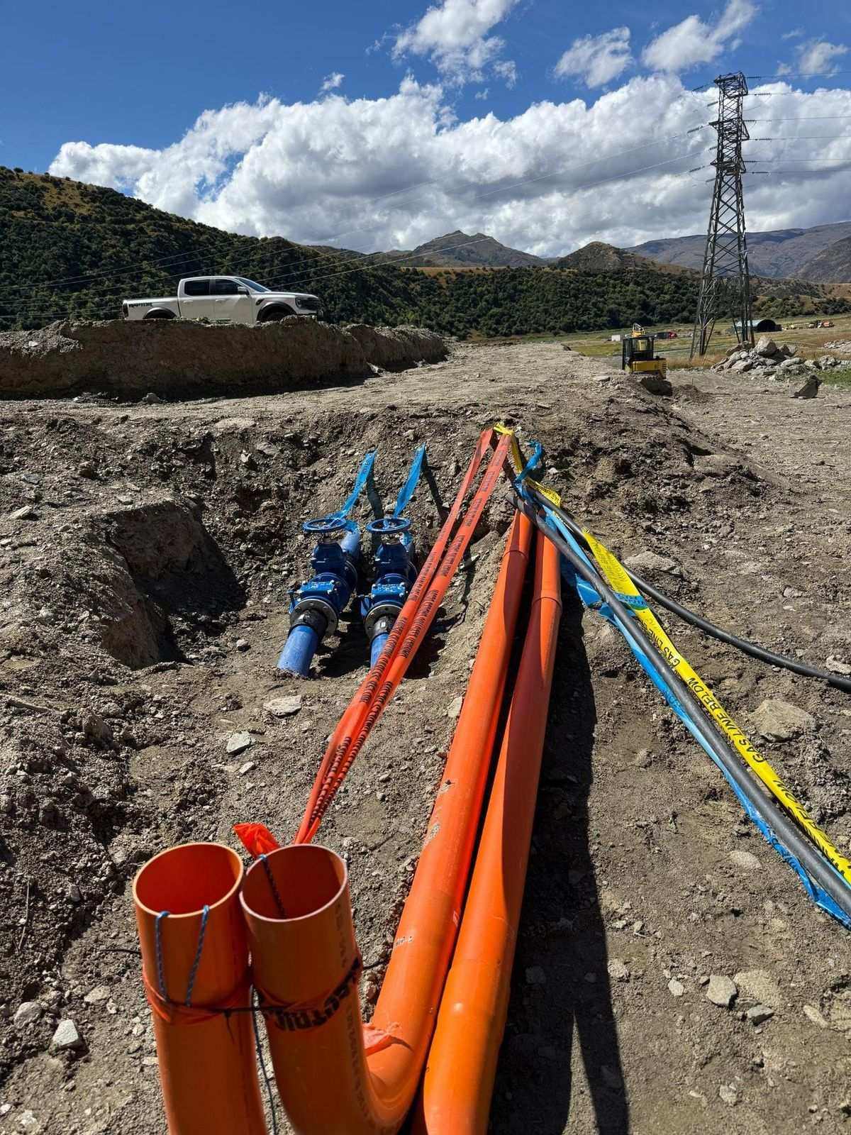 Orange and blue pipe run laid out at the Yards development site